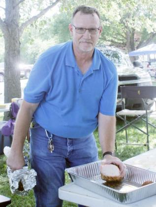 BRIAN SLAGEL shows off the winning Smoked Pork Loin at the 2nd Annual Cook Days BBQ Cook-Off July 18.
