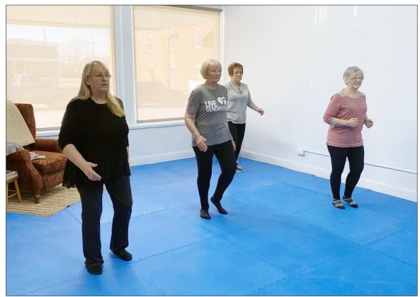 MARILYN BEUTE, left, has opened up The Studio in her Massage Therapy shop in Johnson as an exercise room where she has classes twice a week. Exercising with Marilyn, on to the right, are Mary Gerdes, Mary Lyon, and Roxanne Oestmann. Carol Sisco/Chieftain