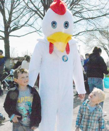 THE EASTER CHICKEN? The little boy on the right isn’t so sure, but the older one is ready to go with the flow of the others gathered around the Johnson County Courthouse in Tecumseh on Saturday, March 30 for the annual Chamber of Commerce Easter Egg Hunt. Ann Wickett/Chieftain