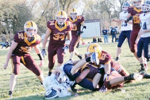 THE DEFENSIVE LINE for the Sterling Jets football squad, l-r, Andrew Richardson (32), Carson McAuliffe (34), Trenton Peery (19) and Tanner McDonald (82) surround Southwest’s ball carrier as their teammates Kaleb Masur (22), aided by Kody Goracke (23) make the tackle.