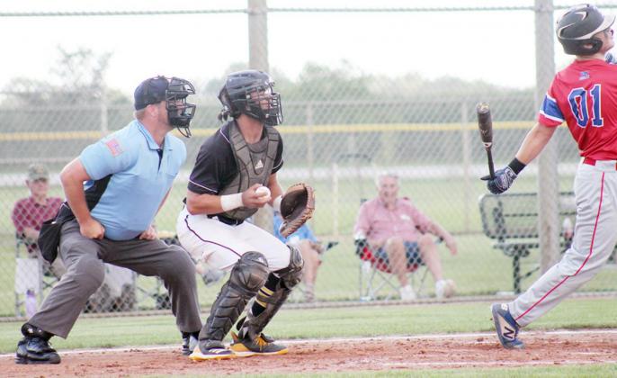 TECUMSEH’S CATCHER KOLE KLEESPIES (13) has the ball in hand and looks to see if there is a tagout to be made on second or third base before throwing the ball back to the pitcher.