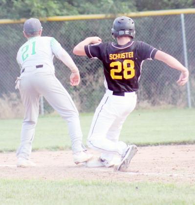 WILL TECUMSEH JUNIORS’ CAMERON SCHUSTER make back to third base in time? The answer is yes!