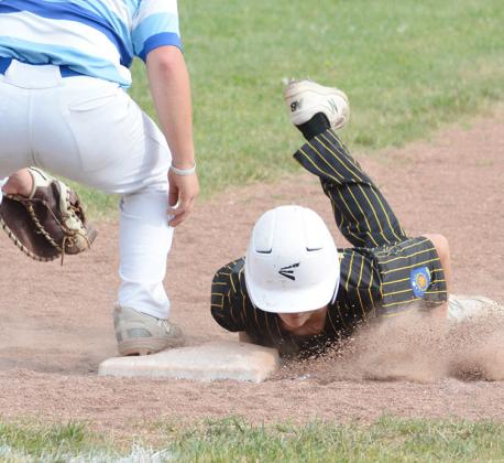 TYLER BLESSING dives head first to into the base after a pick off attempt by Falls City. Cooper Weeks/County Publications