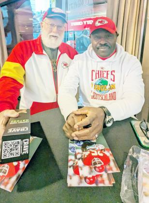 JIM AMOS, left, had the opportunity to take a picture with former Kansas City Chiefs running back Christian “The Nigerian Nightmare” Okoye on board the Chiefs’ Champion Ship docked at the port of Frankfurt, Germany for the game.