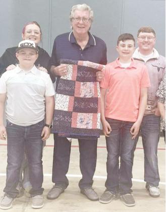 TERRY KAGE, center, was surprised on Easter with a Quilt of Valor presented at his family gathering. Pictured with his grandchildren, clockwise from left front: Brekyn Kage, Tia Parrish, Terry, Tyson Parrish, and Braydn Kage.