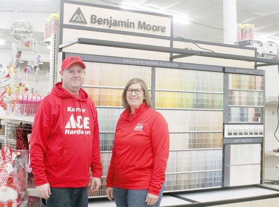 PHIL JUILFS AND PATTI HOLTHUS stand in front of one of their new paint displays in the Kerner hardware store as work continues around them to change from True Value to ACE Hardware. Ann Wickett/Chieftain