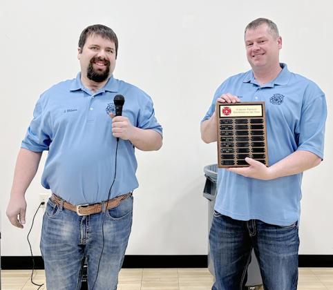SEAN MOSS, right, accepts the 2024 Sterling Fire Department Volunteer of the Year Award from Sterling Fire Chief Jason Ebbers, left.