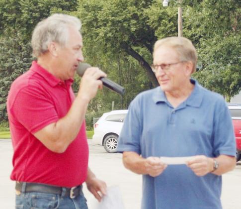 JOEL DUNEKACKE, a member of the Elk Creek Businessmen’s Association, left, presents a check of $2,000 to Randy Baucke, president of the Elk Creek American Legion Post #370, for ongoing improvements to the Legion Hall.