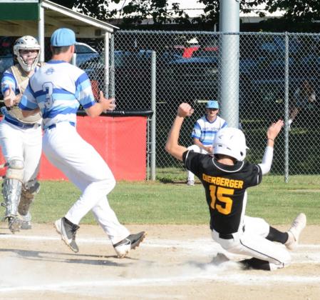 ETHAN DIERBERGER swipes home on an errant pitch Wednesday, June 24 during the second inning vs. Falls City. In Tecumseh’s 6-4 conquest of Falls City, Dierberger also had a hit, scored a run and sacrificed.