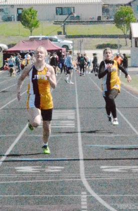 ELLIE LAFFERTYAND TAYLOR TRUSCOTT were competitors in the preliminaries of the 100 Meter Dash at the Lewiston Invitational Track Meet.