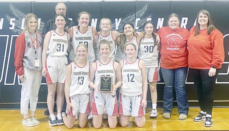 THE JUNIOR HIGH GIRLS BASKETBALL CHAMPIONSHIP was held January 27 in Cook. The A Division winners were the JCC Thunderbirds team, from the left: Front Row - Leighton Beethe, Riley Wellensiek, Sophia Schmid; Back Row - Coach Brittney Teeman, Grace Frederick, Payton Brandt, Abigail Burki, Heidi Reyes, Ailyn Herrera, Student Manager Reese Badertscher, Coach Jacy Pollard and, way in back, Coach Randy Miller.