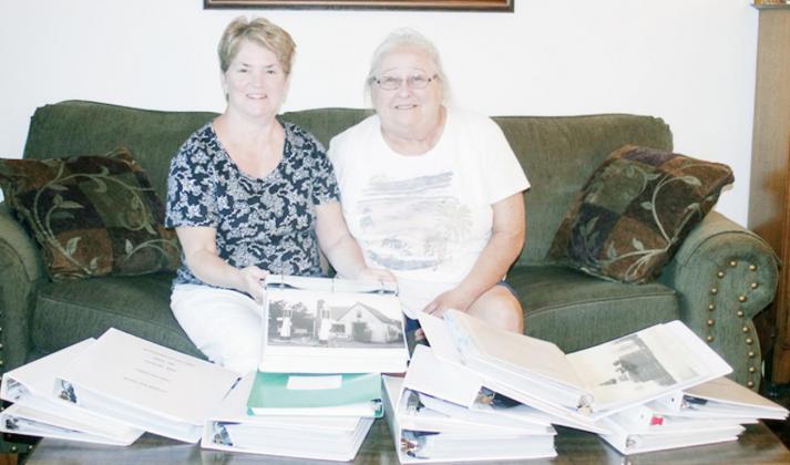 JILL MCAULIFFE, LEFT, AND DENISE HORSTMAN, right, display the collection of photo albums featuring the Sterling Community which they will exhibit at Sterling Village office building on Saturday, September 12.