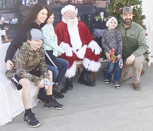 THE GORACKE FAMILY got everyone together for a picture with Santa. From the left: Bryce, Mandy, Hailey, Santa, Owen, and Roy.