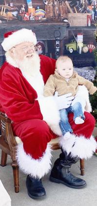THIS LITTLE GUY was visiting Santa for the first time.