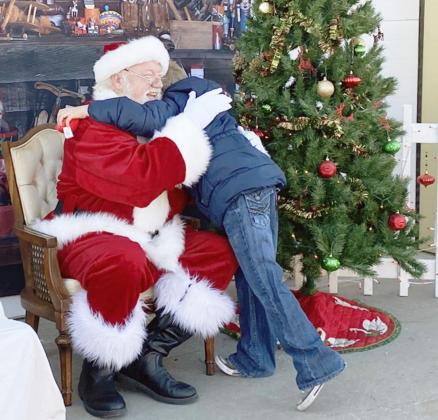 SANTA GOT A HUG from this young man as a thank you for his generosity.